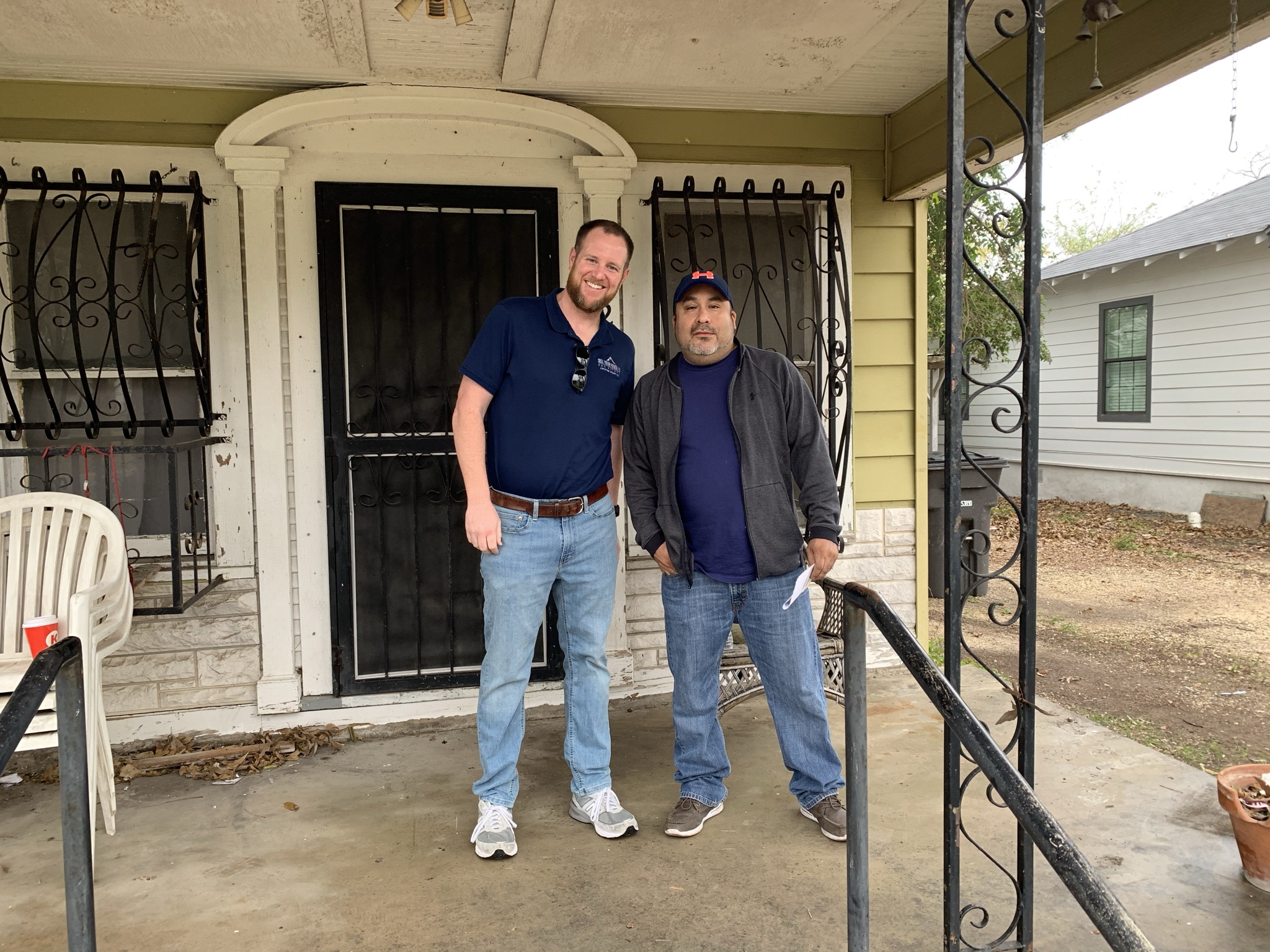 Colby Hager with a seller on the porch of a San Antonio house